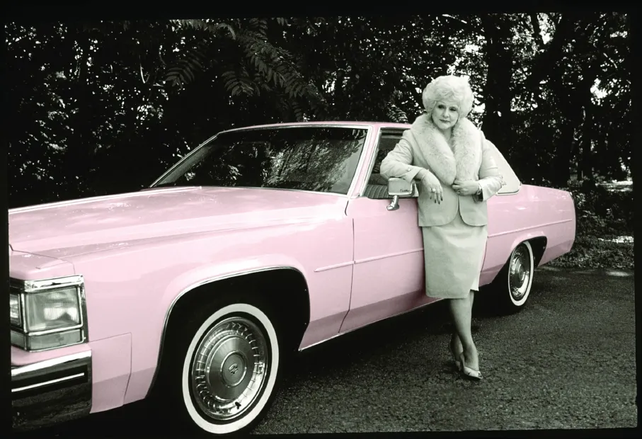 mka-with-pink-cadillac-scaled.webp